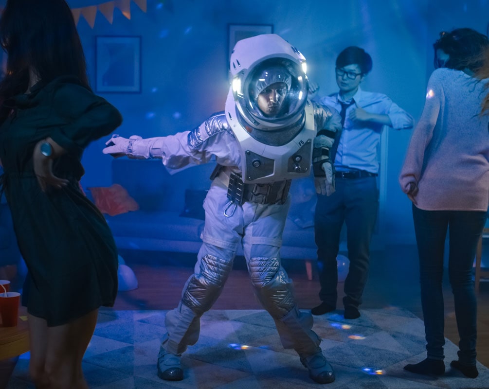 Colleague’s wearing Space suit, data analyst and philosopher costumes doing the robot dance in a Neon lit work party