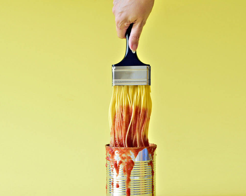 Multichannel Spaghetti attached to a paintbrush dipped in a can of secret digital ingredients the best tomato sauce to success 
